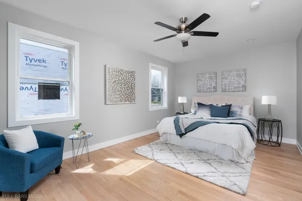 a bedroom with a large bed couch and a window