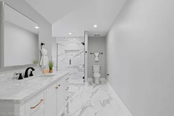 a bathroom with double vanity sink and mirror