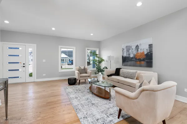 a living room with furniture a rug and a painting