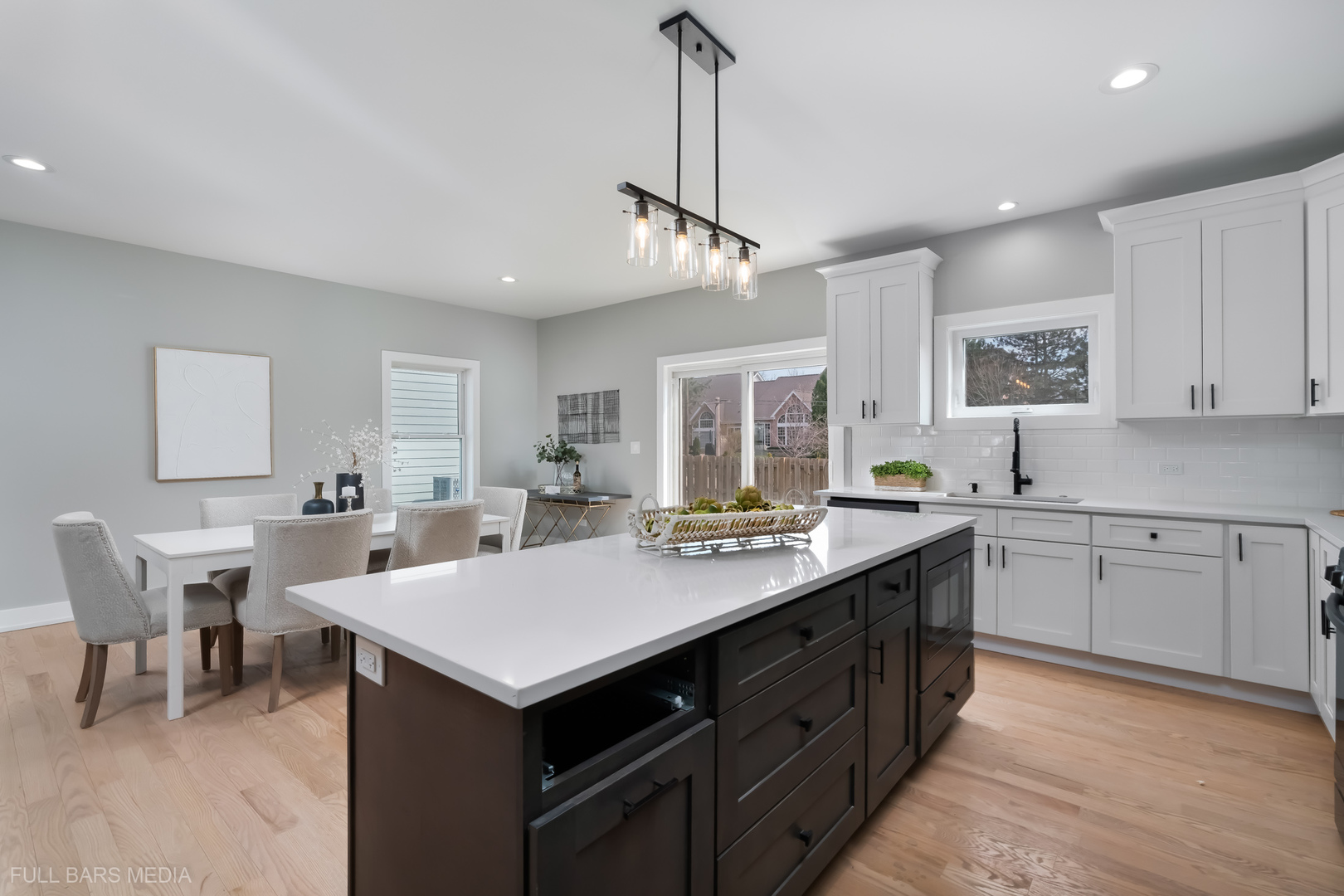 4019 Faith Lane St. Charles, IL 60174 - Photo 10 of 38 a kitchen with a stove a sink a dining table and chairs