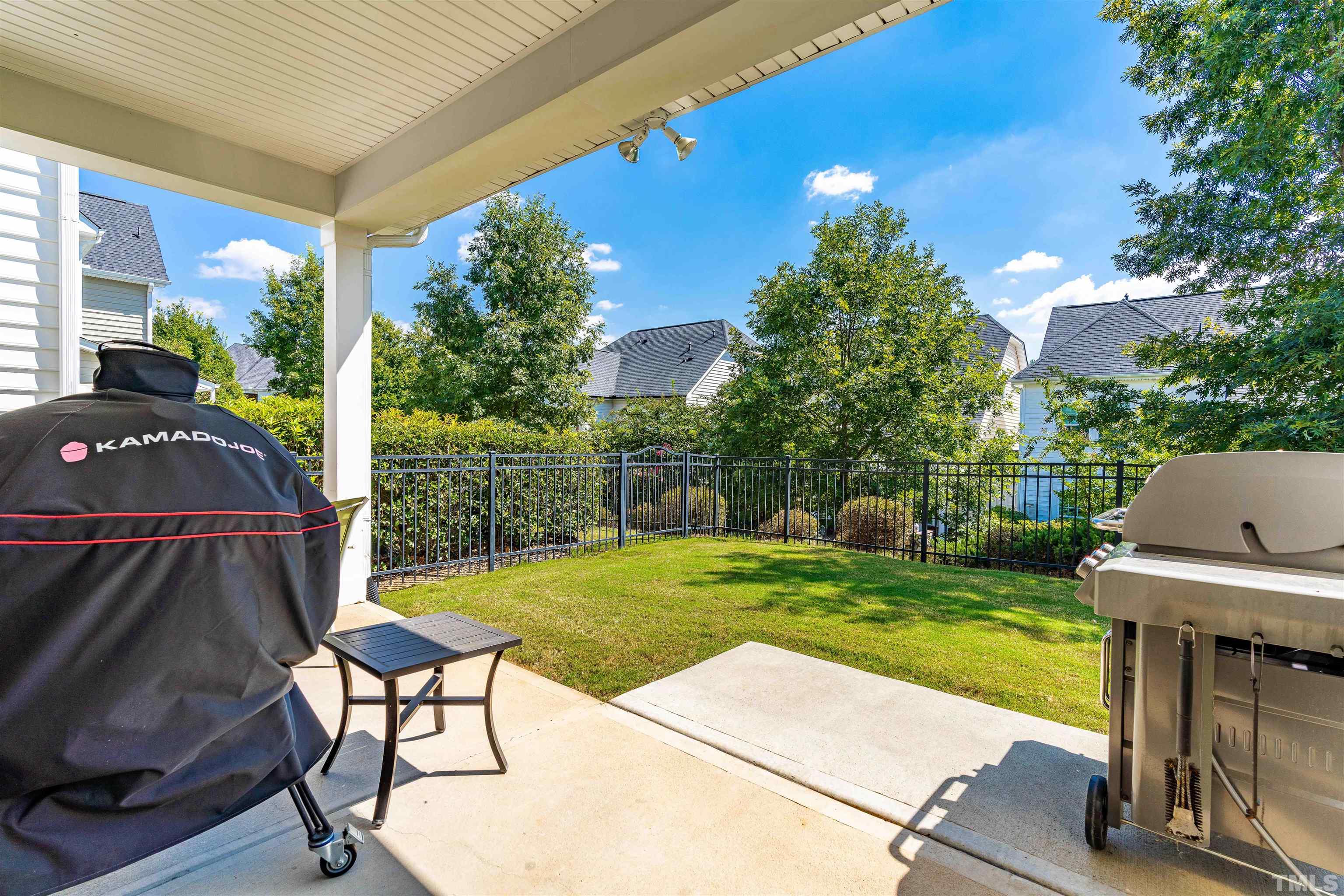 4020 Periwinkle Blue Lane Raleigh, NC 27612 - Photo 36 of 40 a view of a patio with table and chairs potted plants with wooden floor and fence