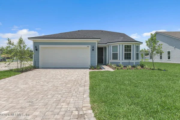 a front view of a house with a yard and garage