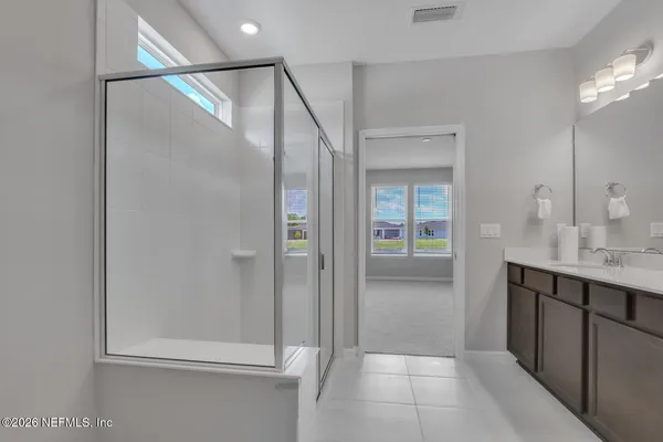 a bathroom with a shower and a sink
