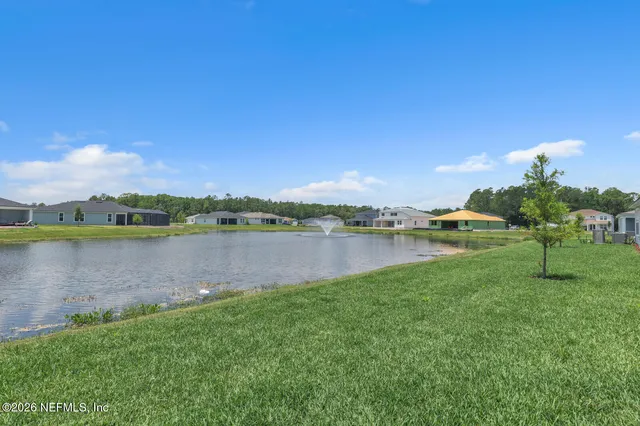 a view of a lake with houses in the back