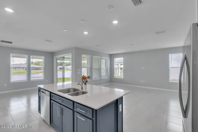a kitchen with sink stove and refrigerator