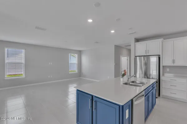 a kitchen with stainless steel appliances granite countertop a sink and refrigerator