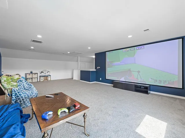 a living room with furniture gym equipment and a large window