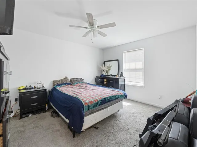 a spacious bedroom with a bed and window