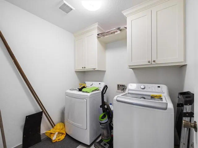 a utility room with sink dryer and washer