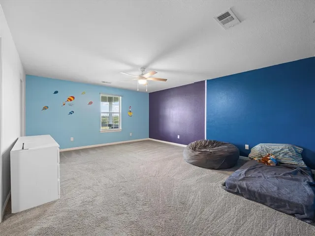 a workspace with a bed and a window