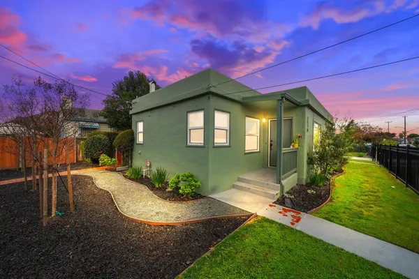 a front view of a house with garden