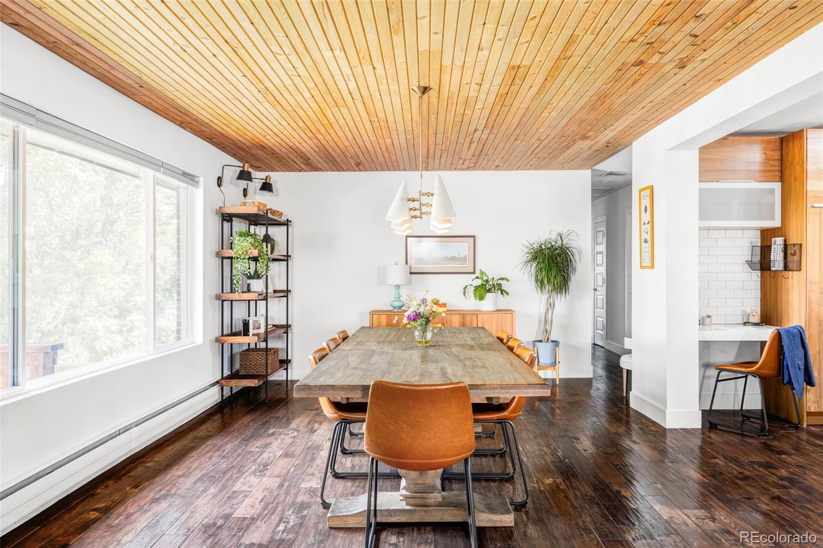 3370 Ward Road Wheat Ridge, CO 80033 - Photo 13 of 42 a dining room with furniture and wooden floor