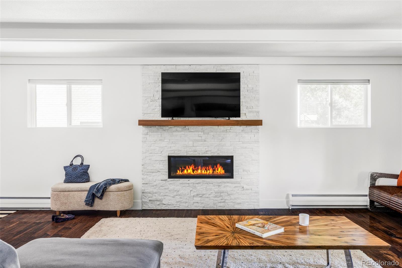 3370 Ward Road Wheat Ridge, CO 80033 - Photo 17 of 42 a living room with furniture and a flat screen tv