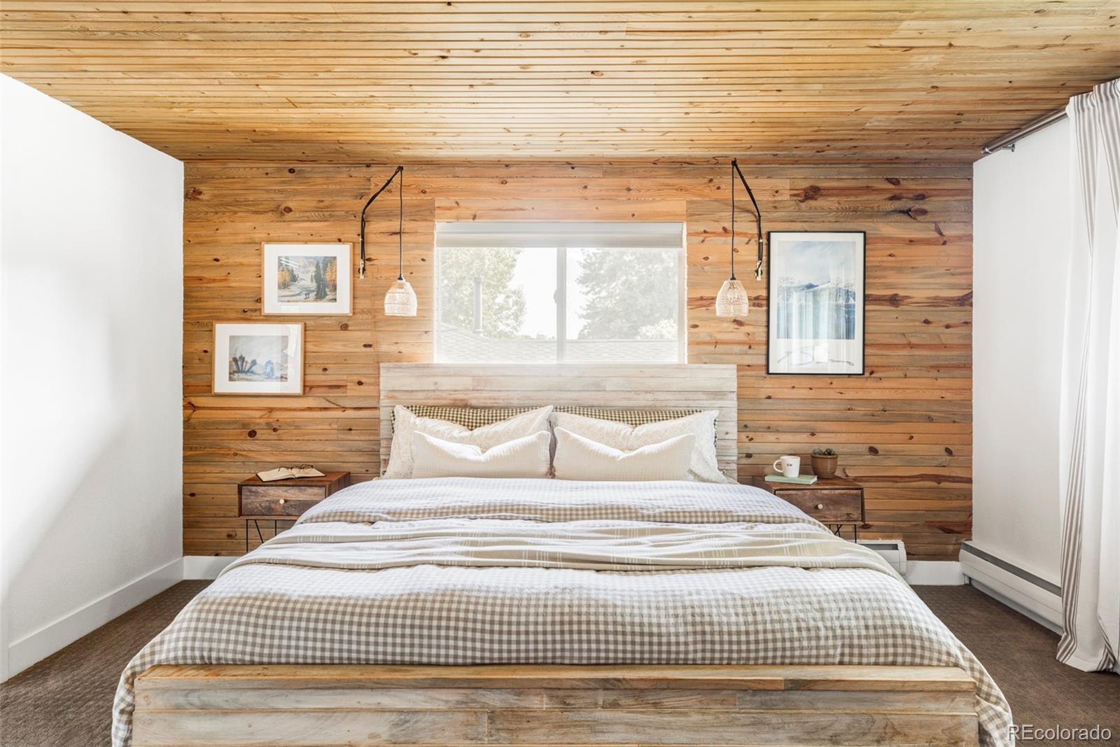 3370 Ward Road Wheat Ridge, CO 80033 - Photo 22 of 42 a bedroom with a bed and wooden floor