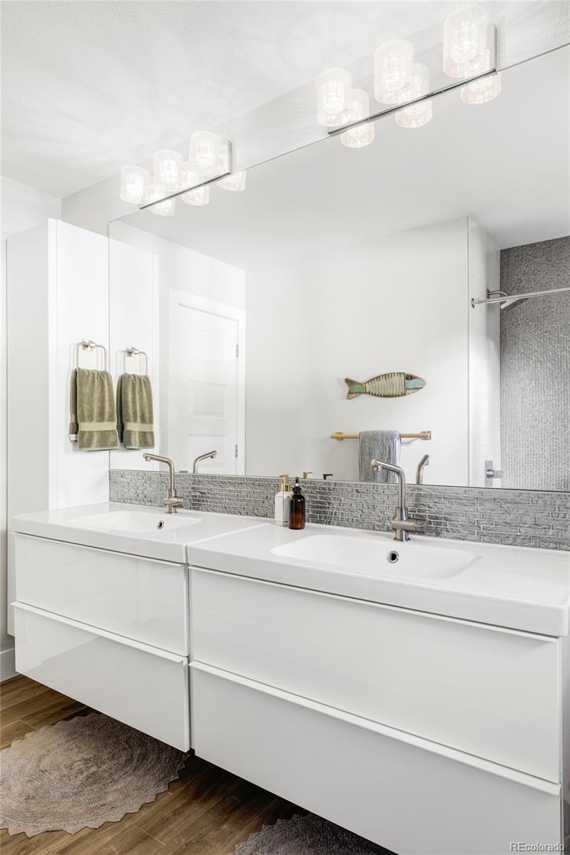 3370 Ward Road Wheat Ridge, CO 80033 - Photo 29 of 42 a bathroom with a double vanity sink and a mirror