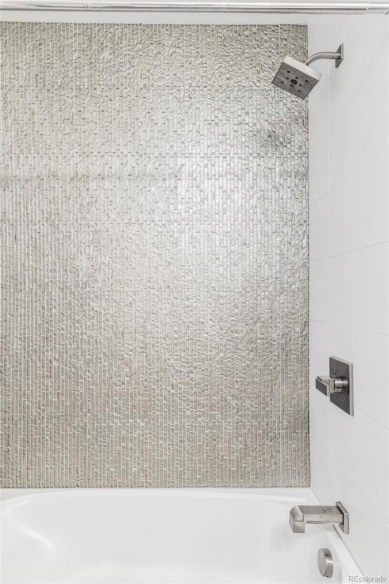 3370 Ward Road Wheat Ridge, CO 80033 - Photo 30 of 42 a bathroom with a bathtub and shower