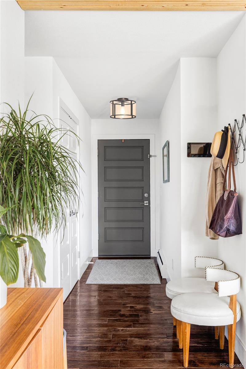 3370 Ward Road Wheat Ridge, CO 80033 - Photo 3 of 42 a view of a hallway with wooden floor and a potted plant