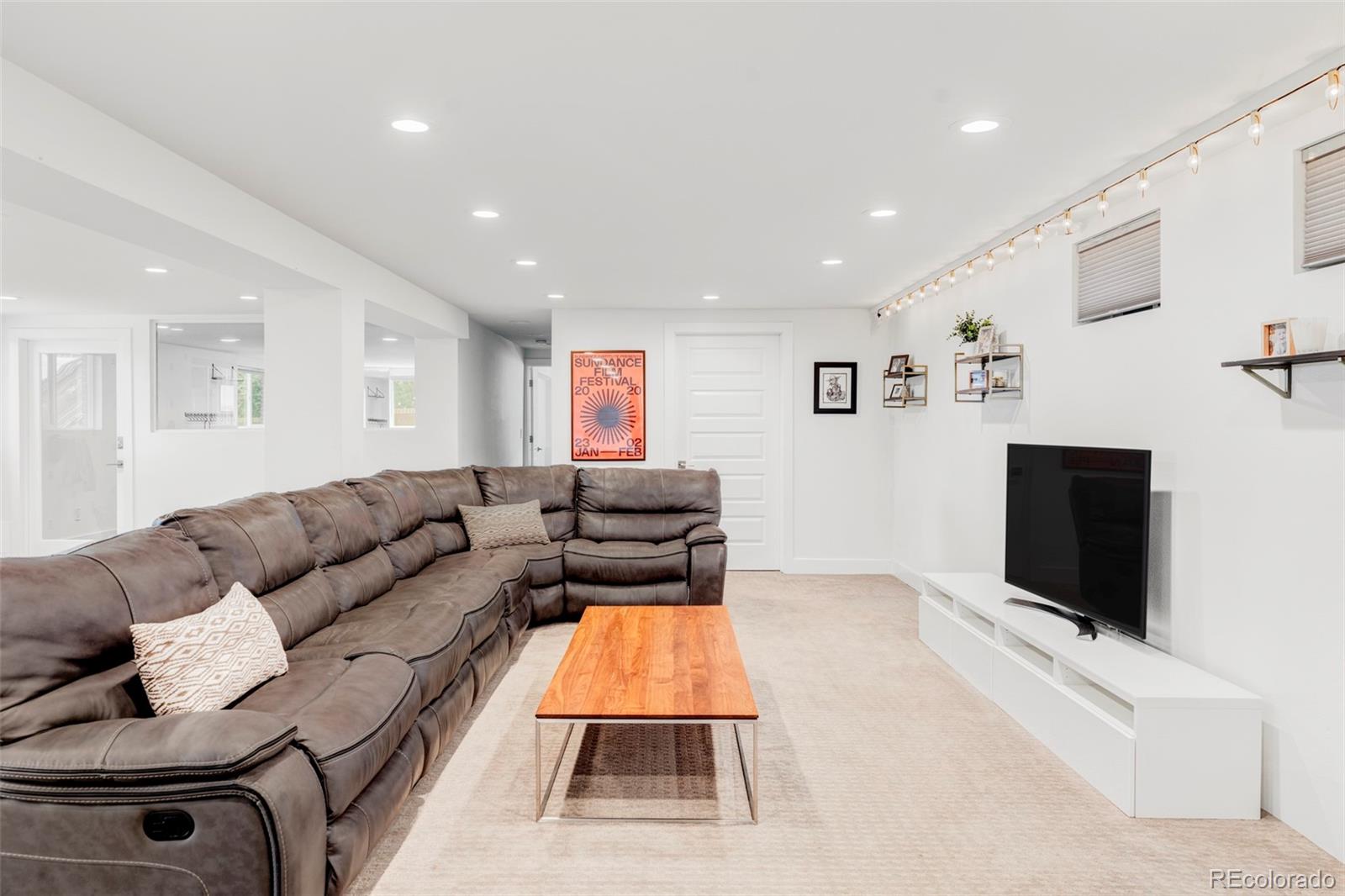 3370 Ward Road Wheat Ridge, CO 80033 - Photo 31 of 42 a living room with furniture and a flat screen tv