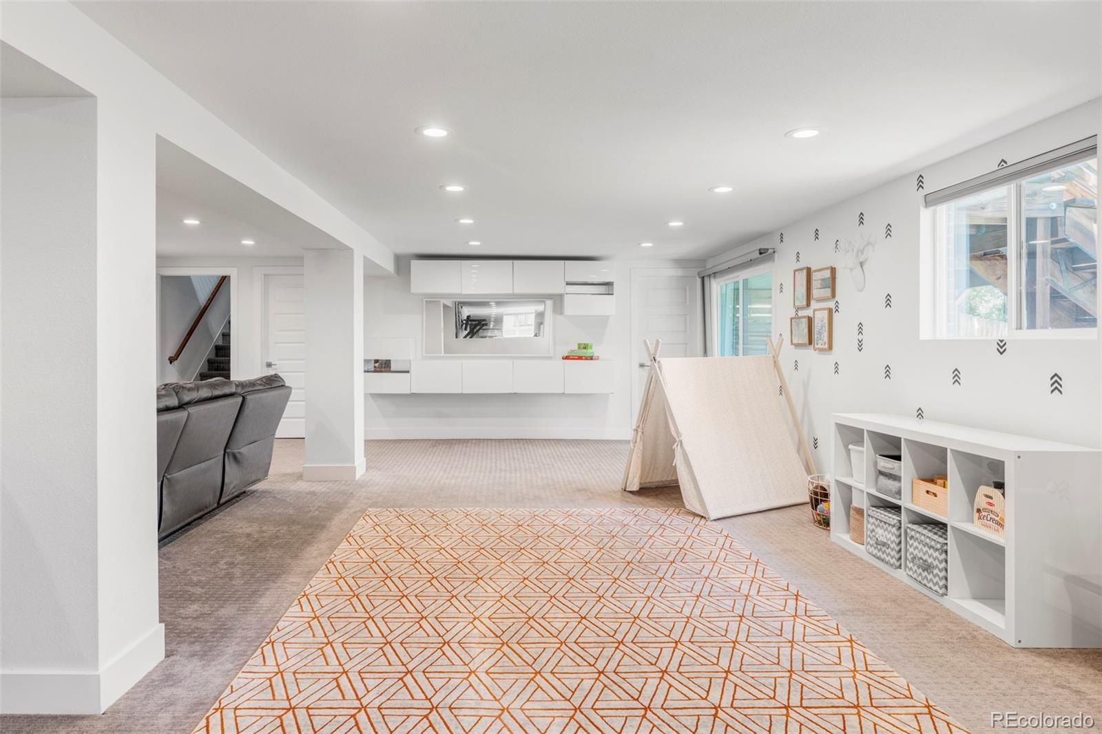 3370 Ward Road Wheat Ridge, CO 80033 - Photo 33 of 42 a living room with stainless steel appliances furniture a rug and a kitchen view