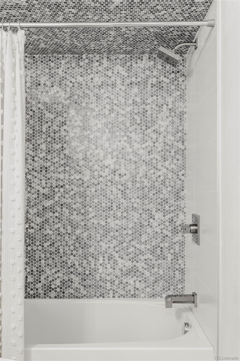 3370 Ward Road Wheat Ridge, CO 80033 - Photo 36 of 42 a bathroom with a shower and a bathtub