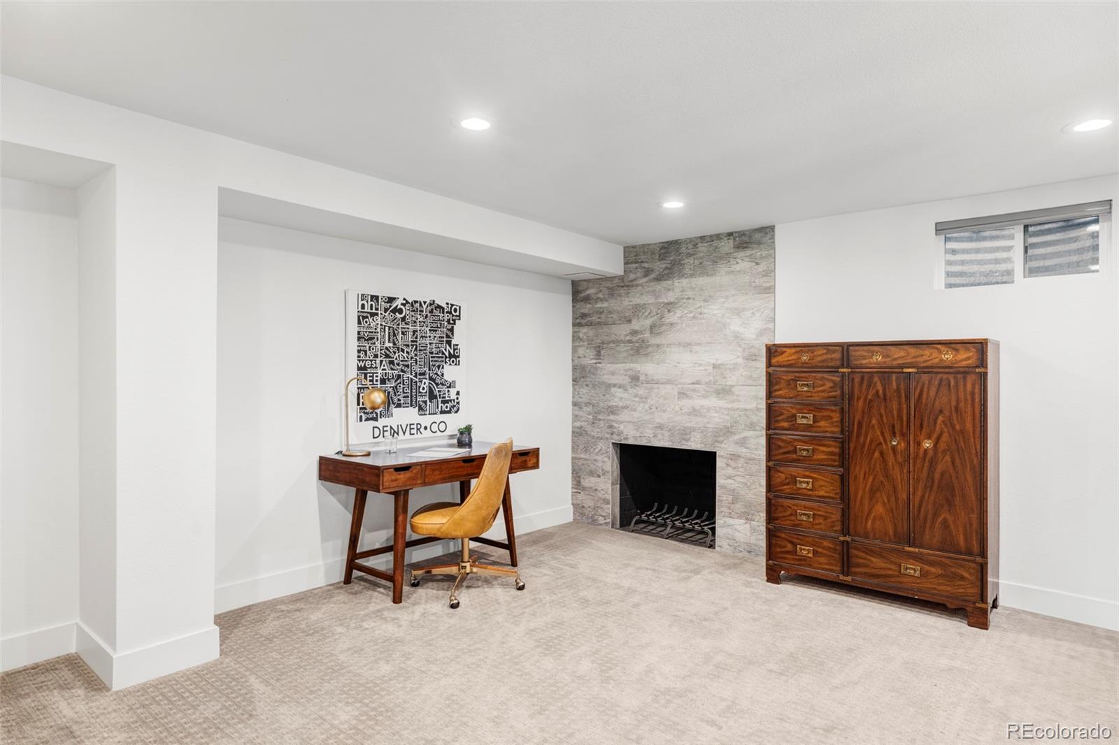 3370 Ward Road Wheat Ridge, CO 80033 - Photo 37 of 42 a living room with furniture and a fireplace