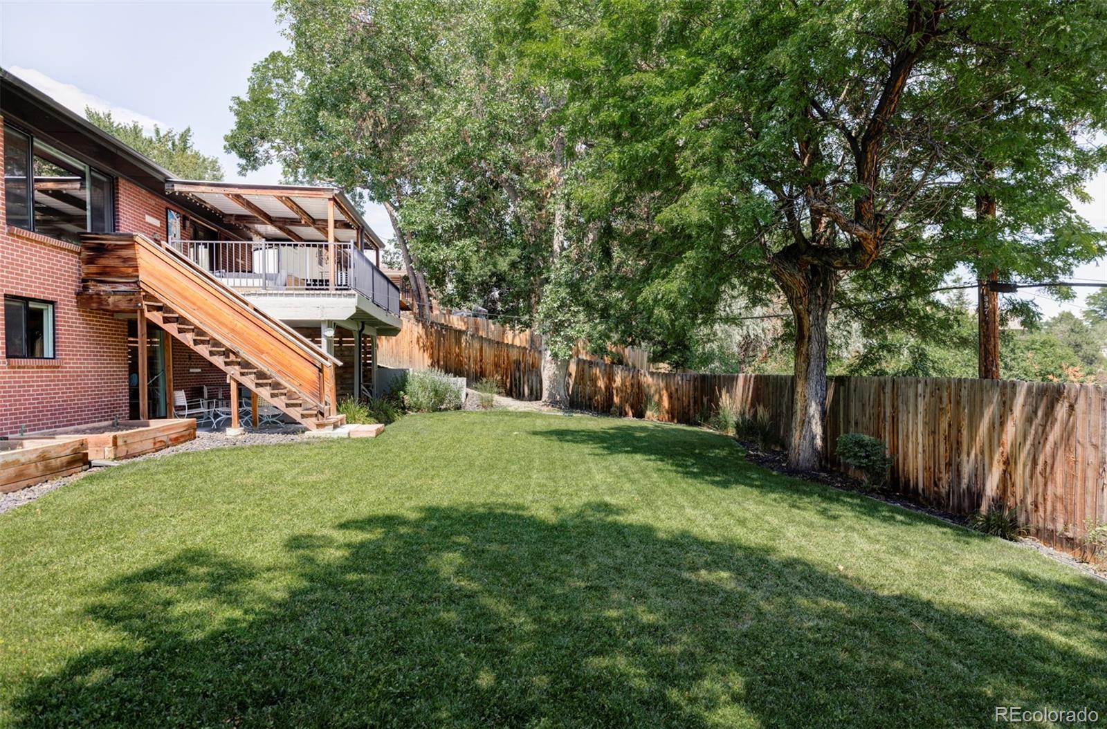 3370 Ward Road Wheat Ridge, CO 80033 - Photo 39 of 42 a view of a house with a yard