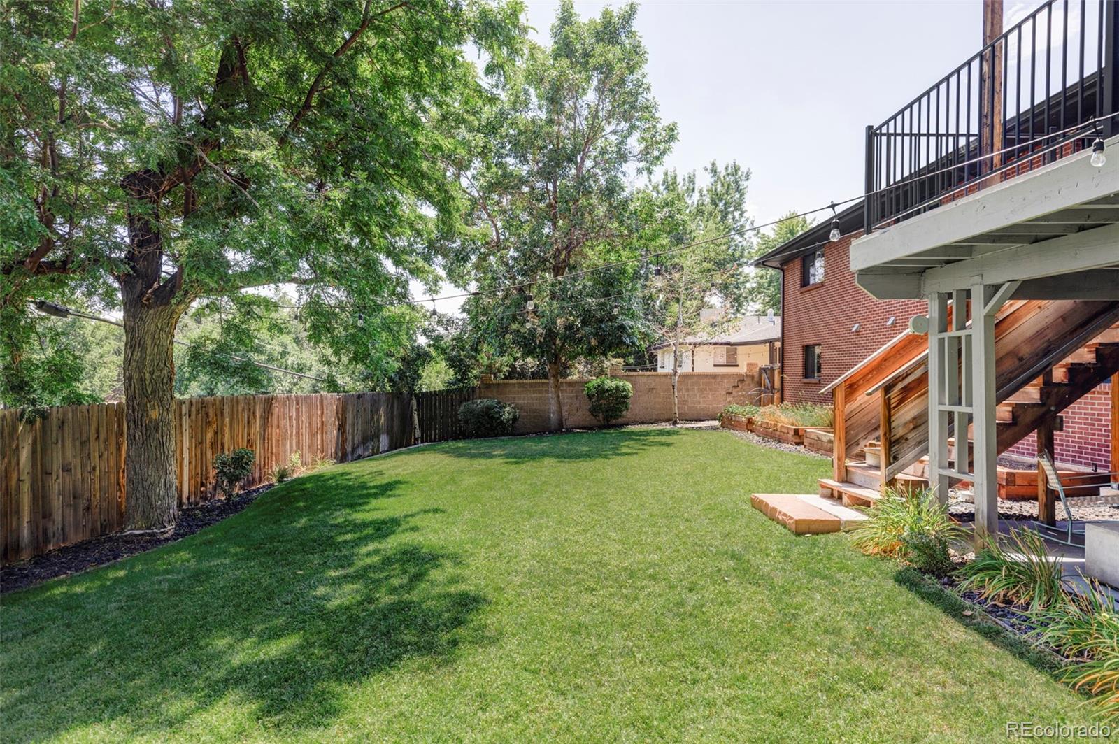 3370 Ward Road Wheat Ridge, CO 80033 - Photo 40 of 42 a view of a big yard next to a house