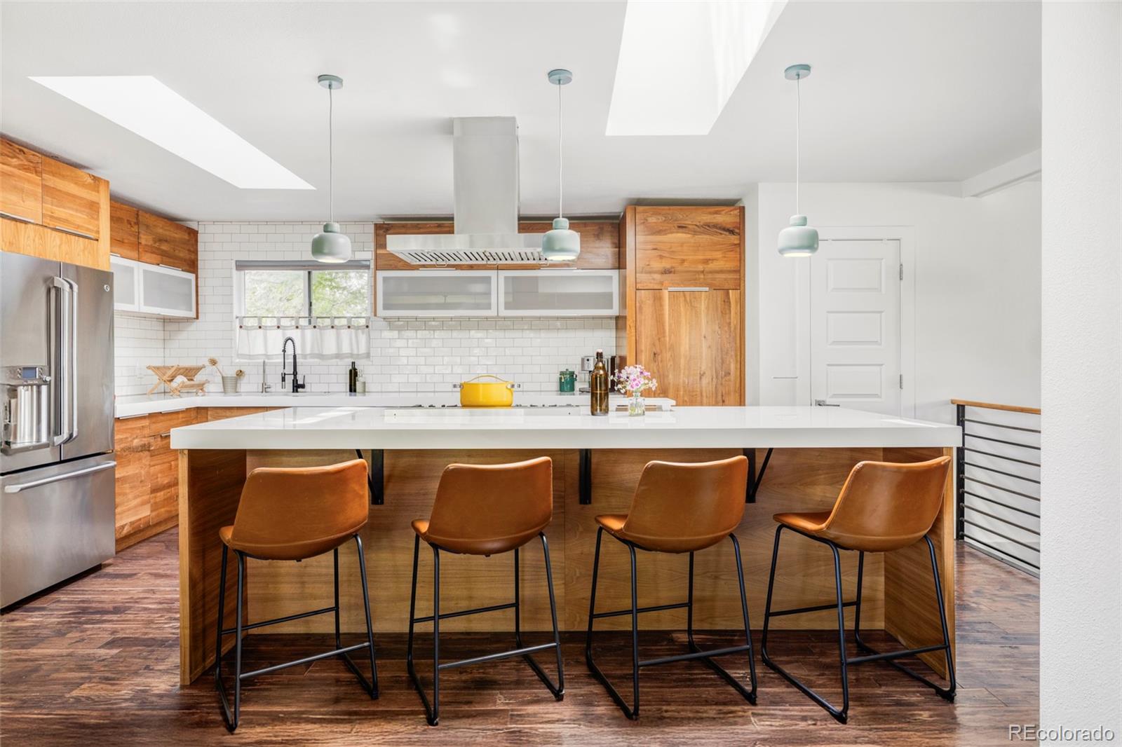 3370 Ward Road Wheat Ridge, CO 80033 - Photo 4 of 42 a kitchen with a table chairs sink and cabinets