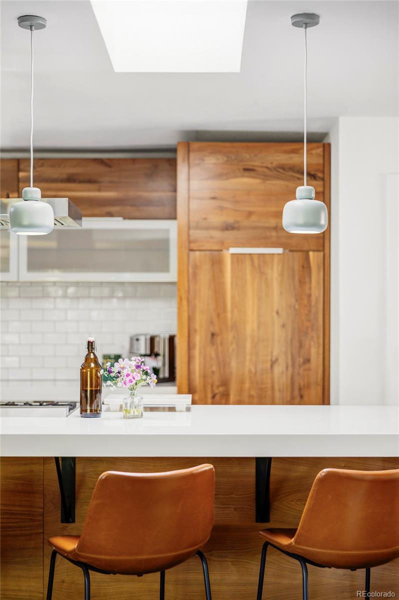 3370 Ward Road Wheat Ridge, CO 80033 - Photo 5 of 42 a room with a table chairs and a potted plant