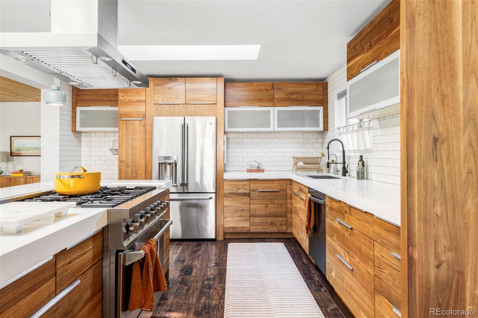 3370 Ward Road Wheat Ridge, CO 80033 - Photo 9 of 42 a kitchen with stainless steel appliances granite countertop a sink stove and refrigerator