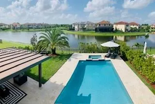 a view of a lake with a bench next to a yard