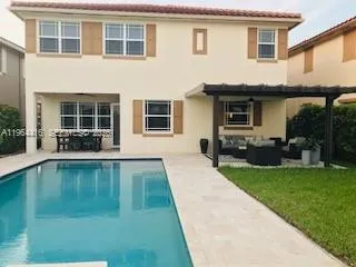 a swimming pool with outdoor seating and yard