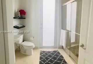a bathroom with a toilet and a shower