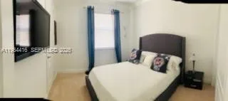 a bedroom with a bed and a mirror