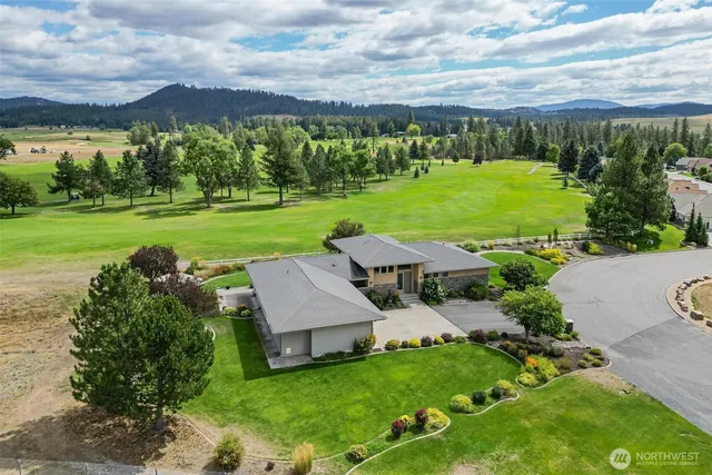 an aerial view of a house with big yard