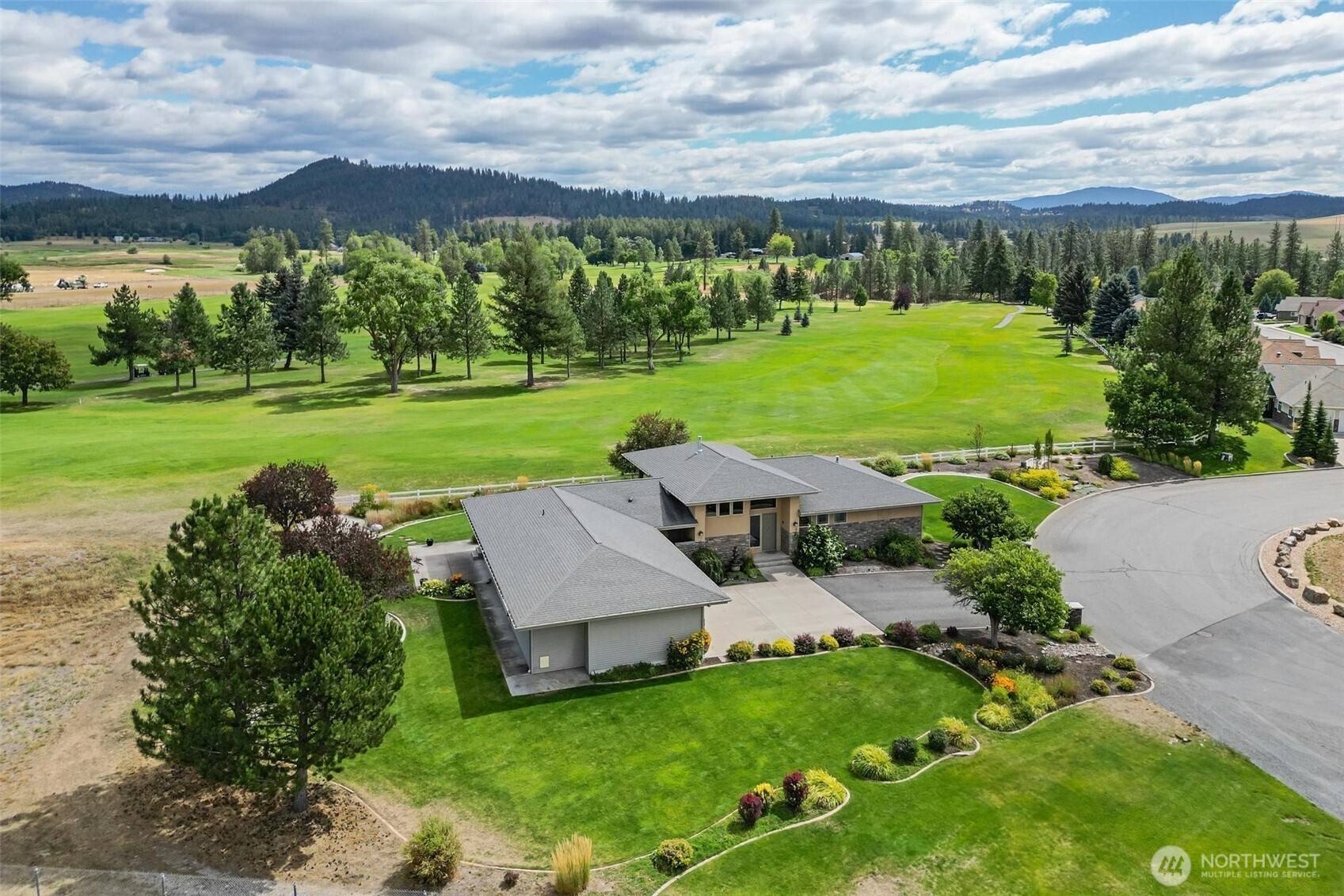 an aerial view of a house with big yard
