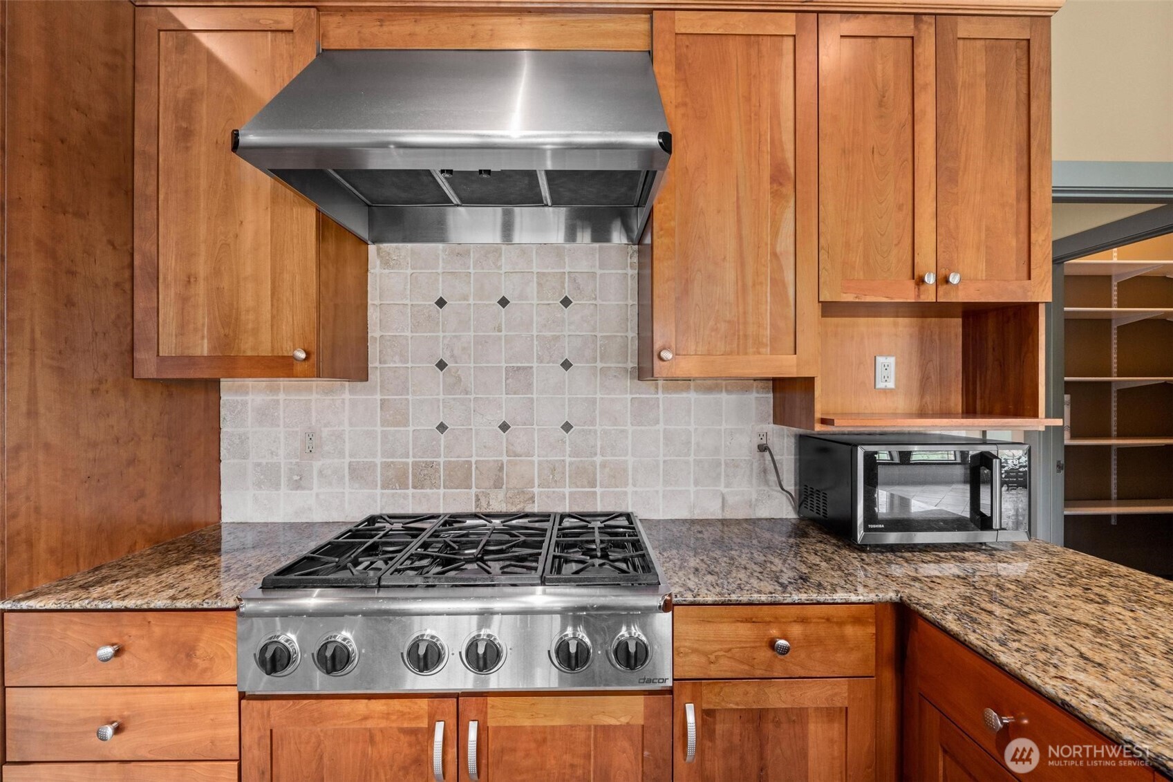 1900 Tamarack Street Colville, WA 99114 - Photo 11 of 40 a kitchen with granite countertop a stove a sink dishwasher and cabinets with wooden floor