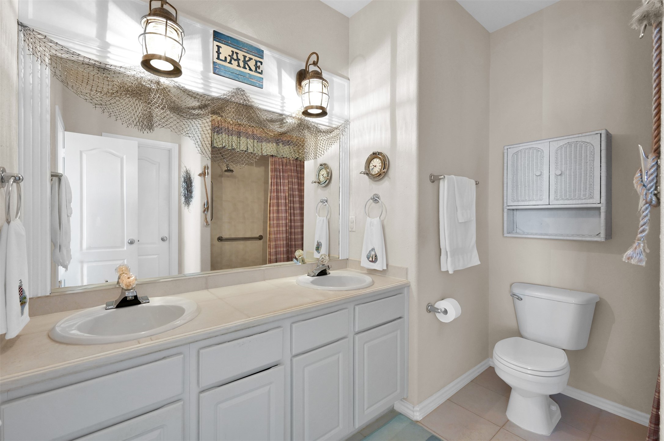 15 Regency Point Conroe, TX 77356 - Photo 17 of 32 a bathroom with a toilet sink and mirror