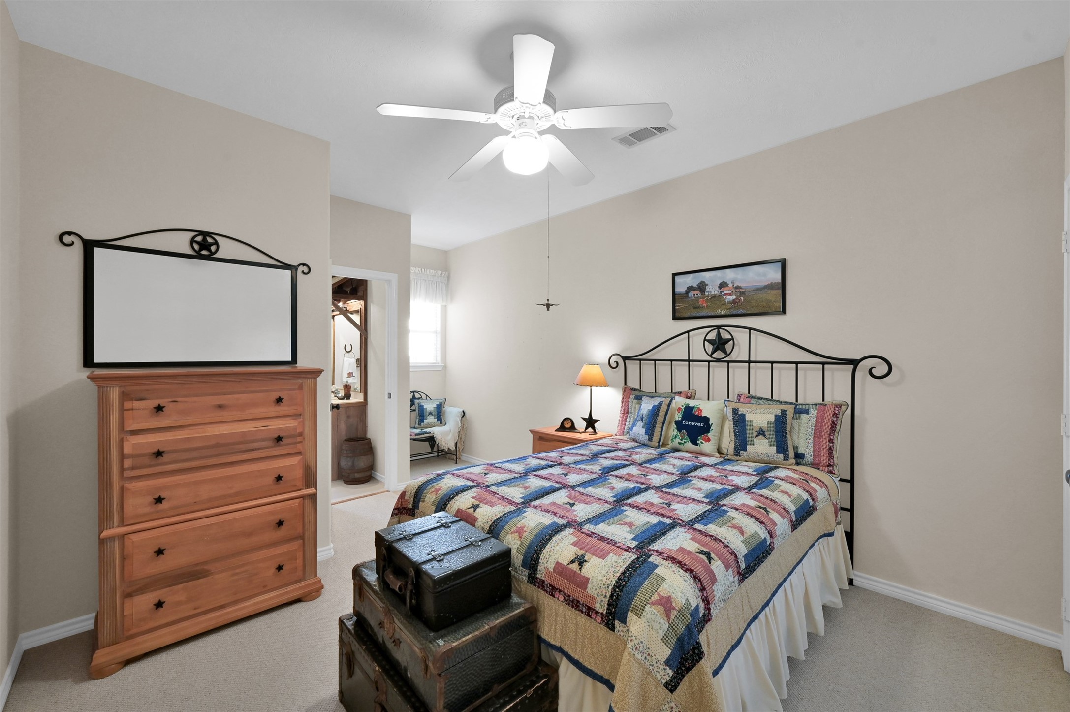 15 Regency Point Conroe, TX 77356 - Photo 22 of 32 a bedroom with a bed and a dresser