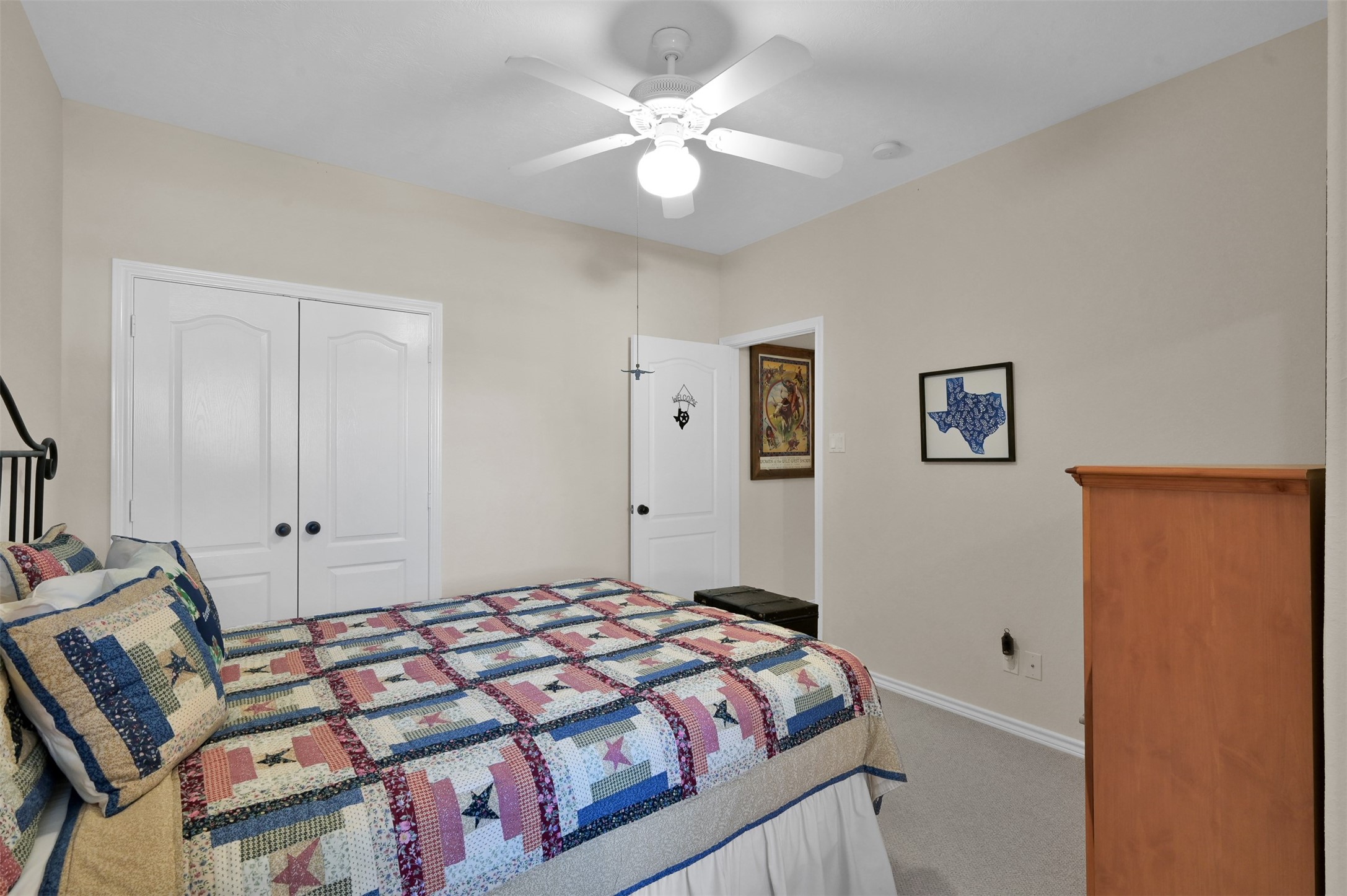 15 Regency Point Conroe, TX 77356 - Photo 23 of 32 a bedroom with a bed and a chandelier