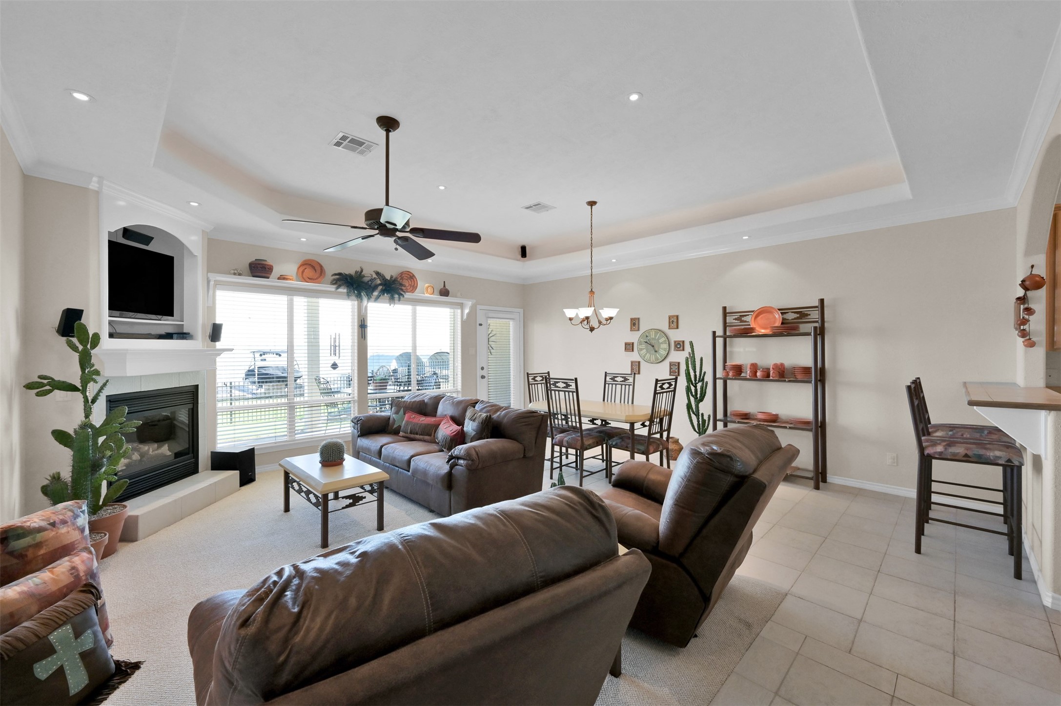 15 Regency Point Conroe, TX 77356 - Photo 6 of 32 a living room with furniture a fireplace and a flat screen tv