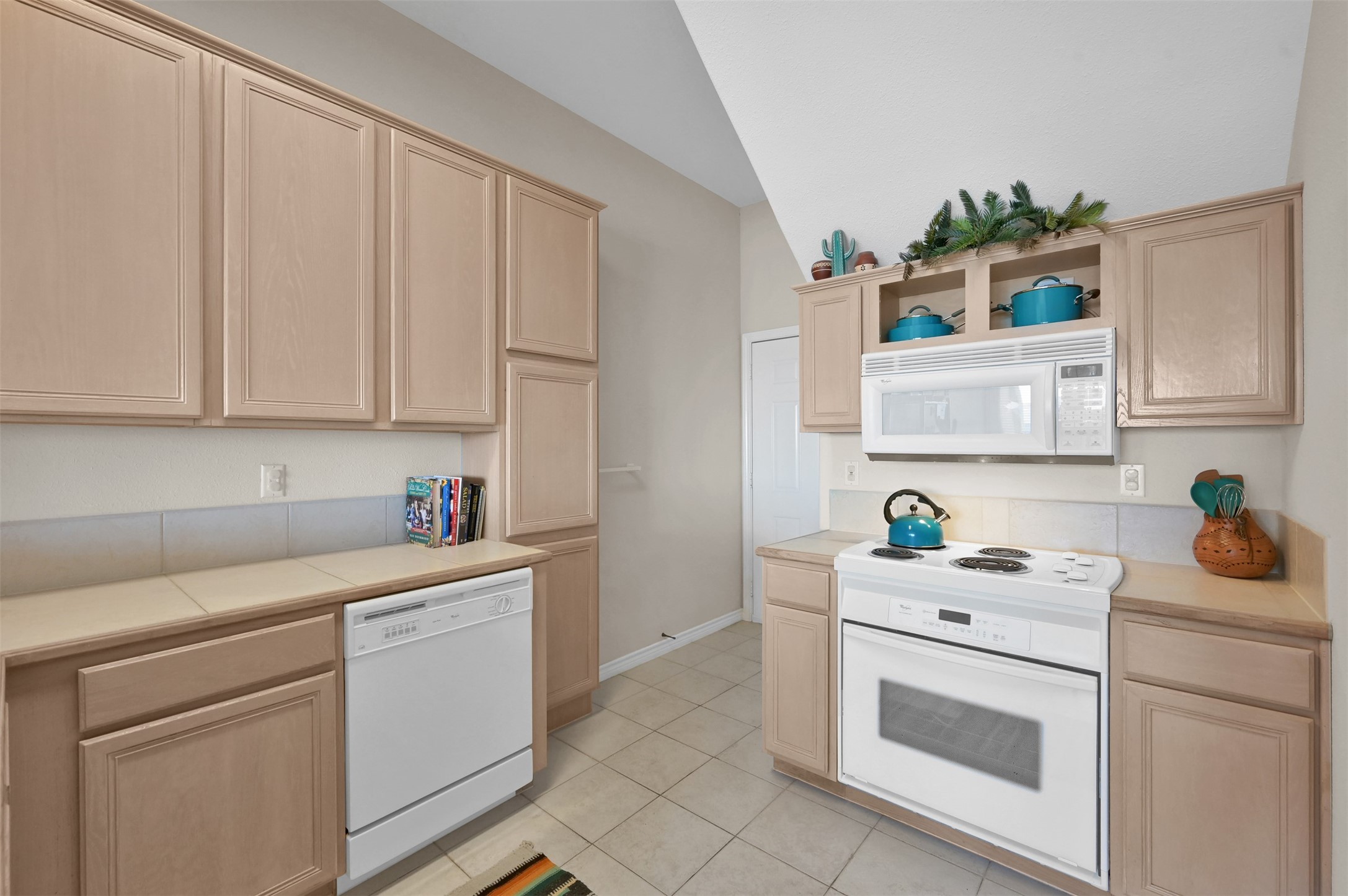 15 Regency Point Conroe, TX 77356 - Photo 10 of 32 a utility room with stainless steel appliances white cabinets sink and a window