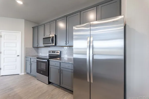a kitchen with a refrigerator and a sink