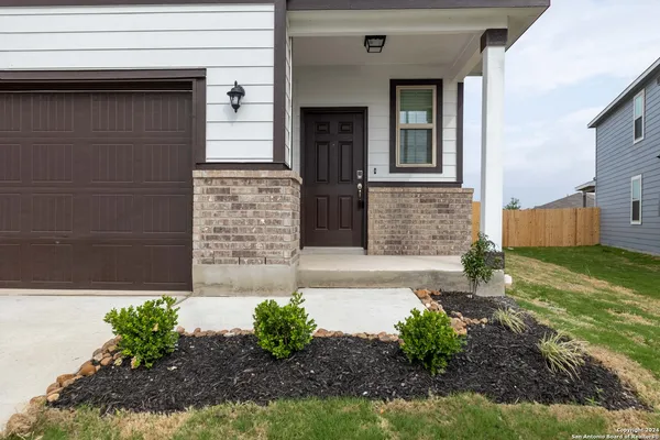 a front view of a house with garden