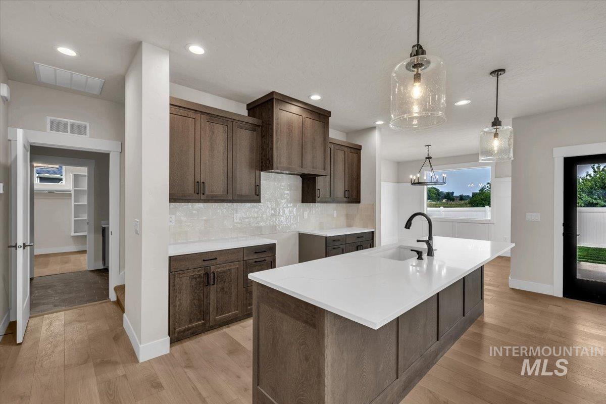 72 South Ravine Way Nampa, ID 83687 - Photo 8 of 48 Central kitchen island with a white countertop and integrated sink