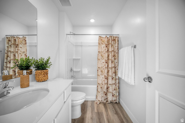 2202 Wolverine Way, Unit 2529 Washington, UT 84780 - Photo 17 of 27 Contemporary bathroom featuring a single vanity with a white countertop and integrated sink, chrome faucet, and wood-finish flooring
