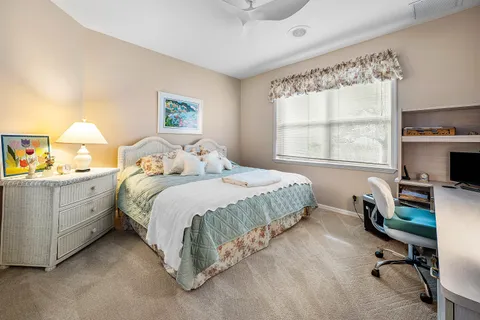 a living room with furniture and a book shelf