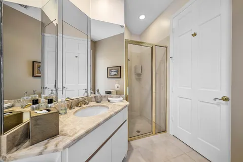 a bathroom with a tub sink and mirror