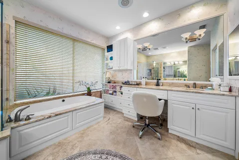 a view of a house with swimming pool and sitting area