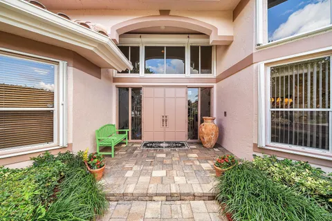 a living room with furniture and potted plants